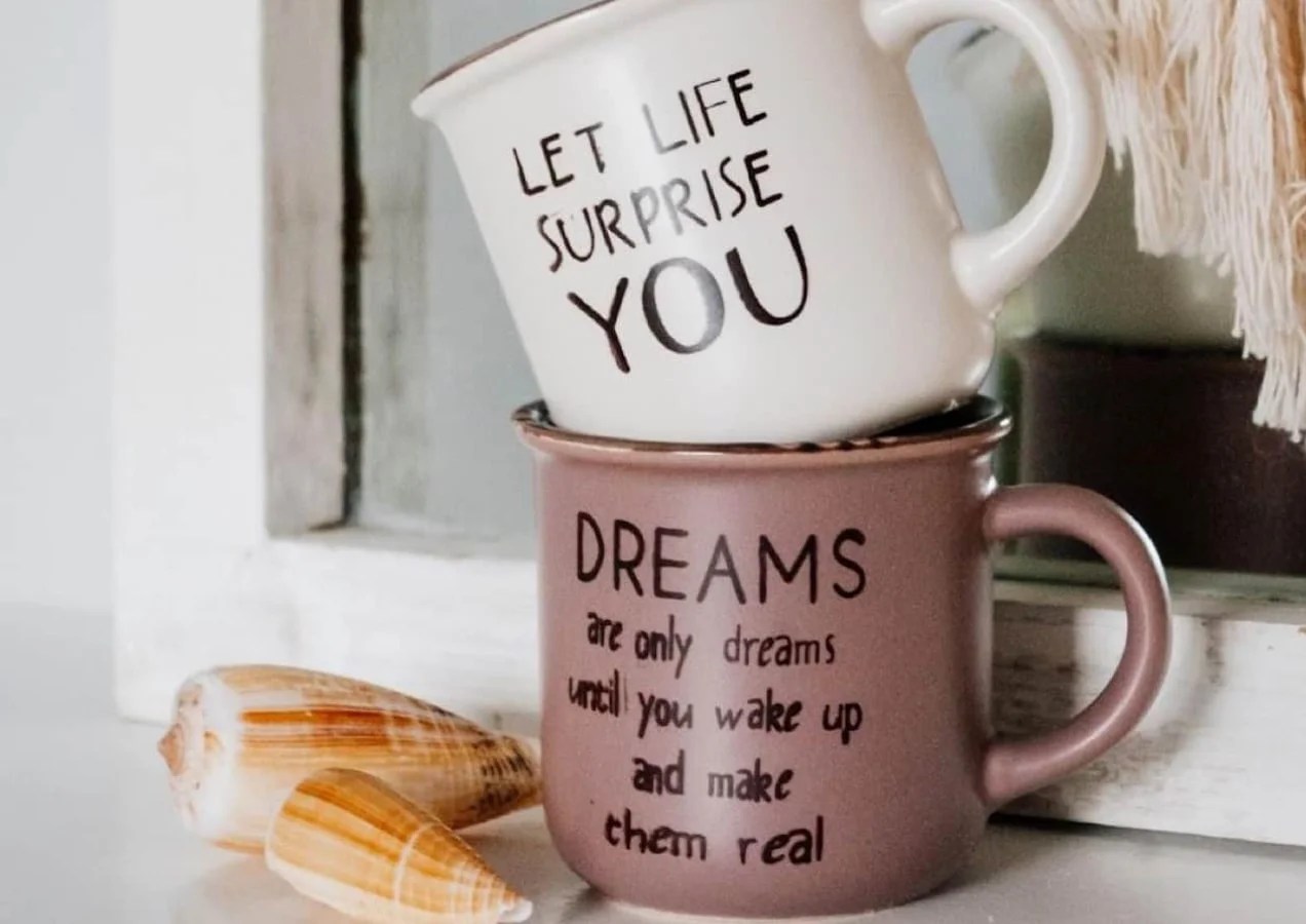 mugs with fun phrases stacked on top of one another