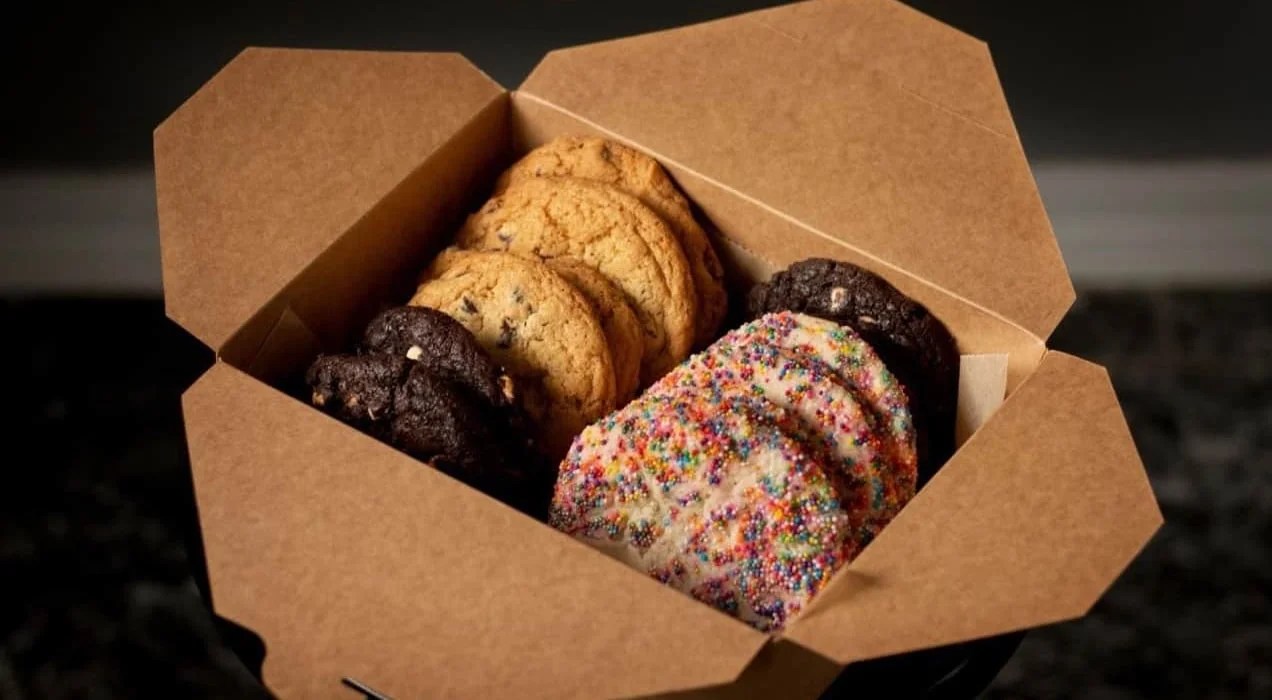 cardboard box of chocolate chip, chocolate, and sprinkle cookies