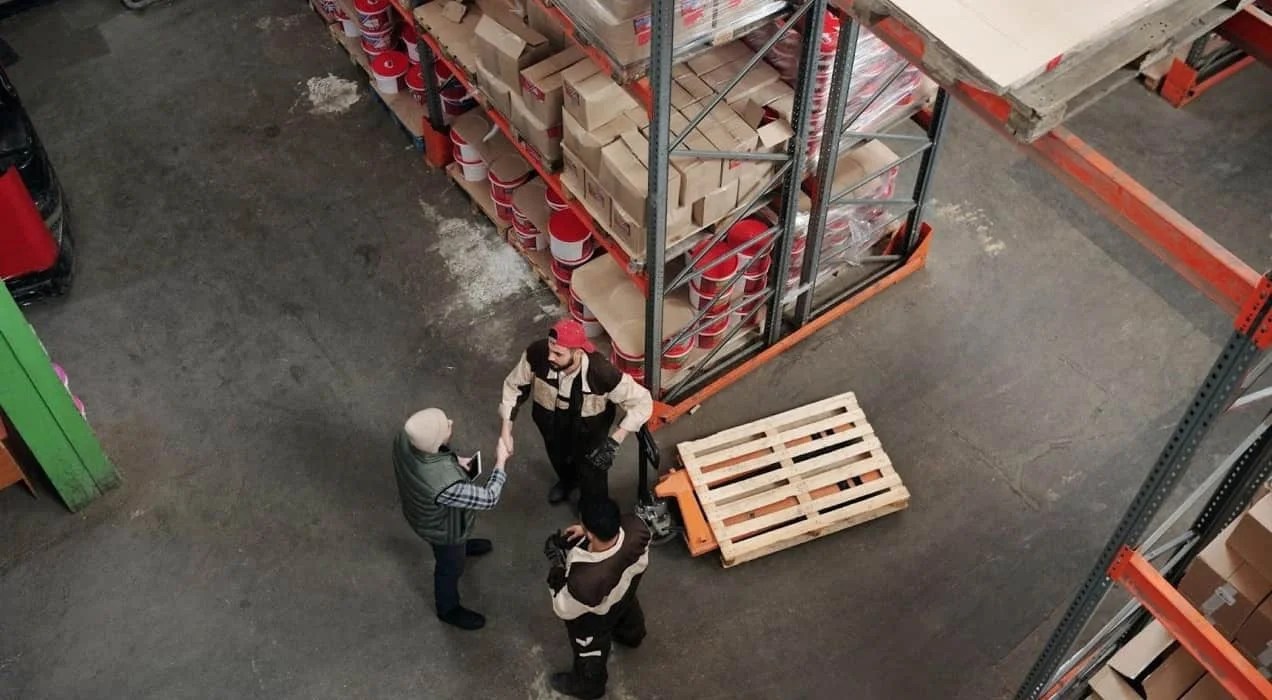 people shaking hands on a warehouse floor