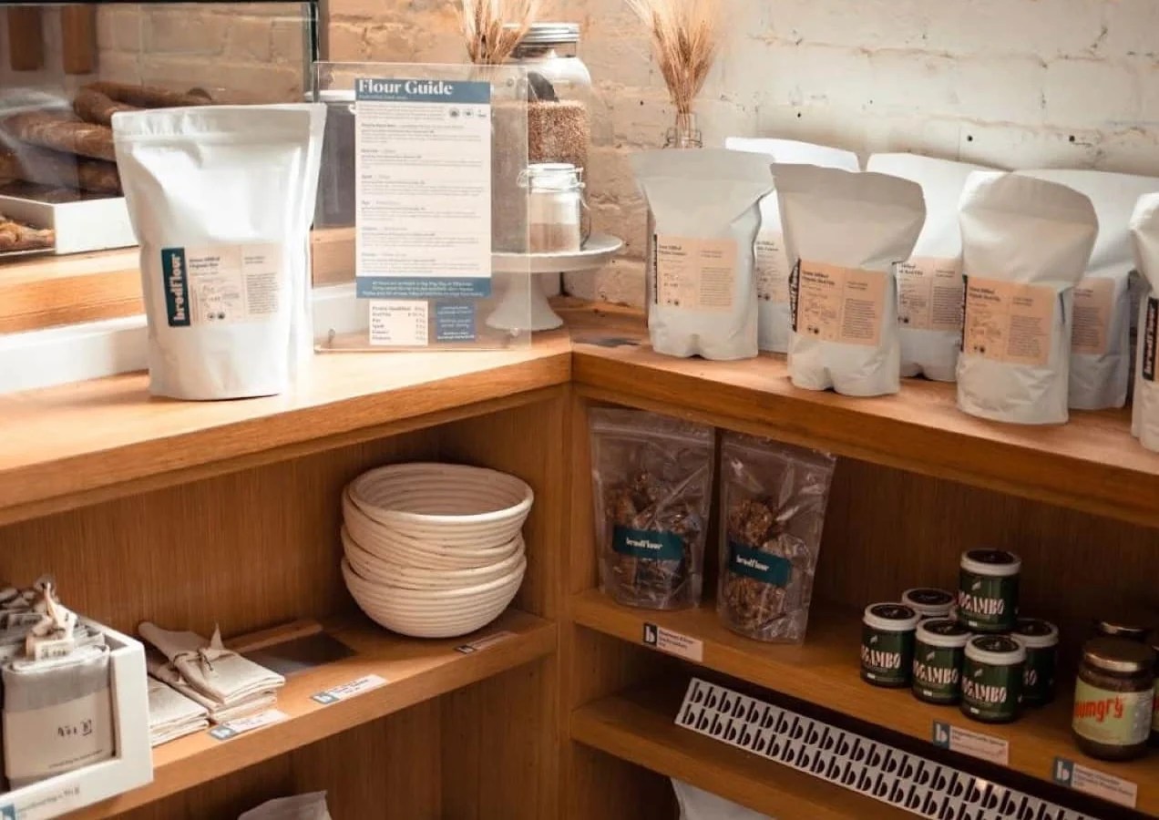 wooden shelves with granola, jams, and other products